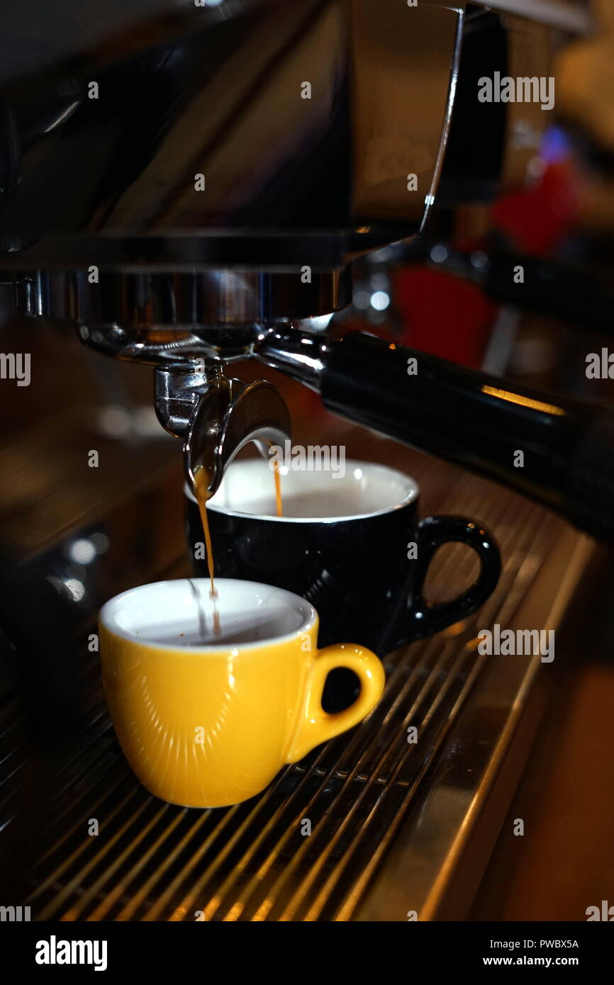 Barista making coffee using a coffee maker Stock Photo Alamy