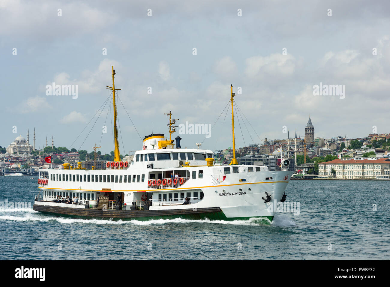 A large passenger ferry sailing on the Bosphorus with Galata Tower and Suleymaniye mosque in the background, Istanbul, Turkey Stock Photo