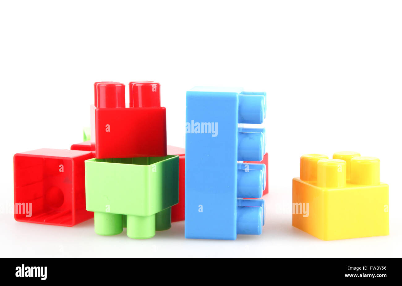Plastic colorful toy blocks on white background Stock Photo - Alamy