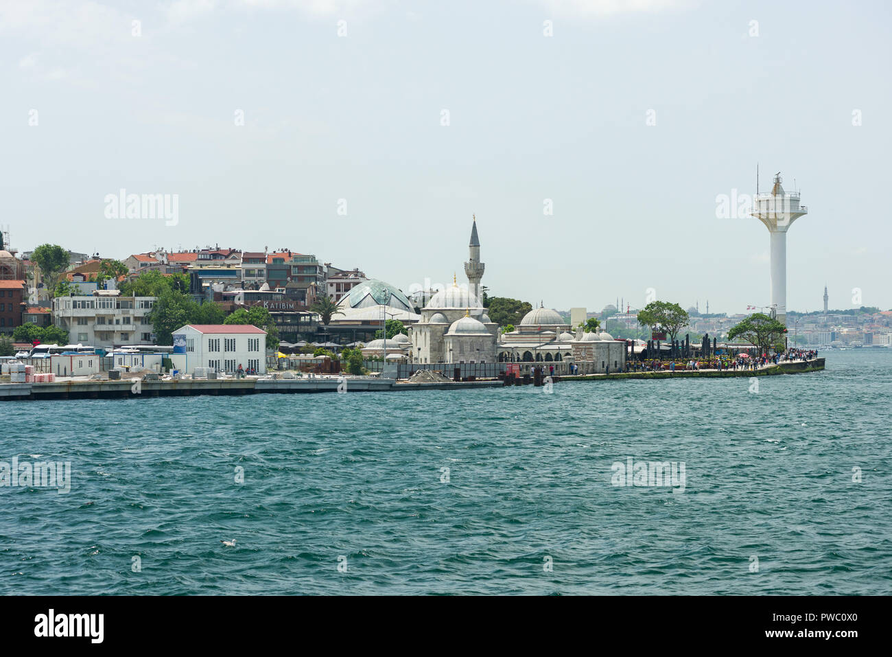 Buildings, mosque and Bosphorus Traffic Signalling Tower in the Üsküdar area of Istanbul from the Bosphorus Strait on a sunny day Stock Photo
