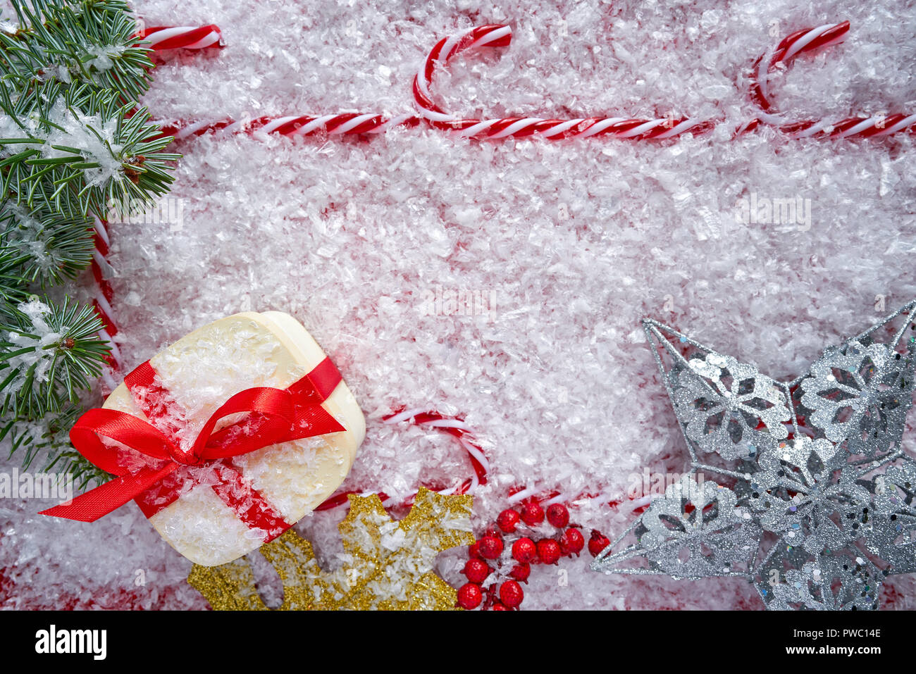 Christmas gift and candy cane frame on snow background border Stock