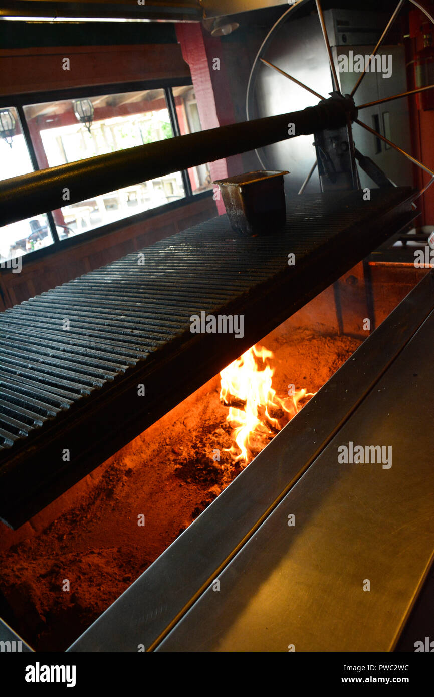 An interior grill being heated by chef for Boss Oyster seafood