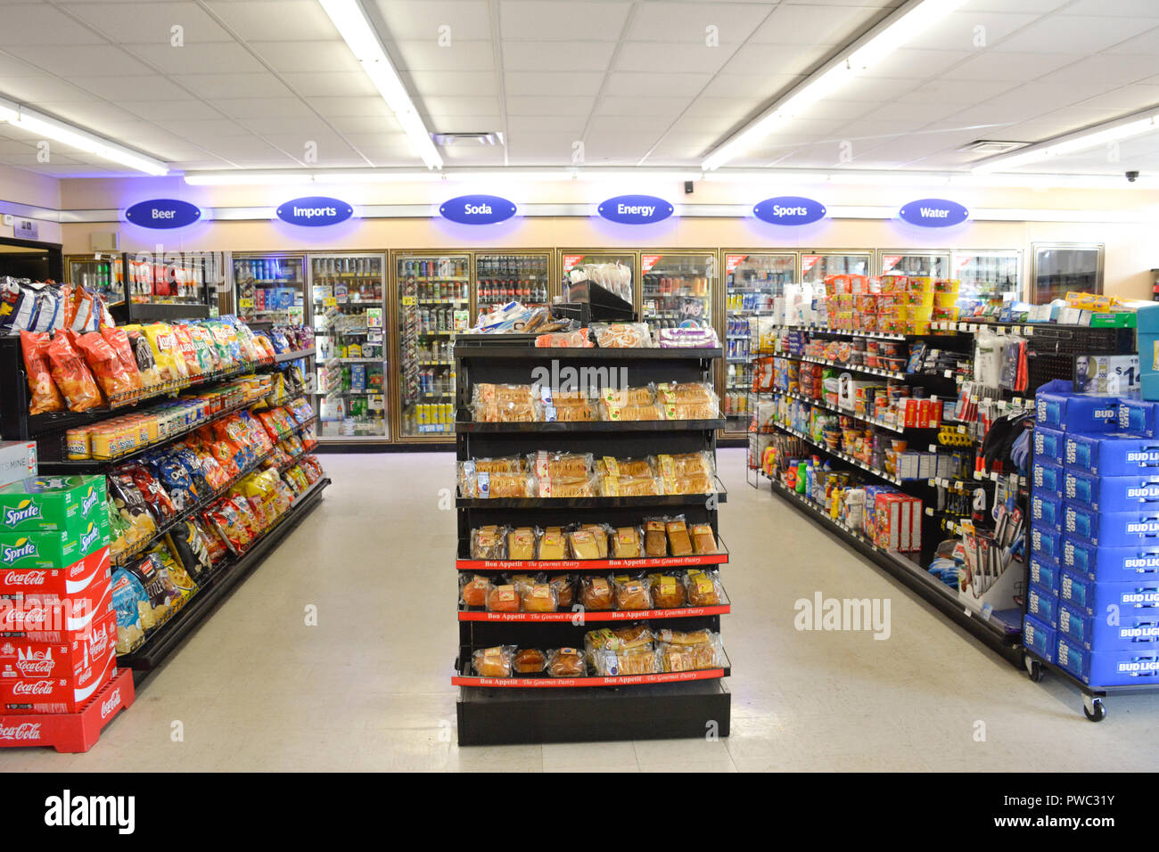 Interior of generic convenience market with aisles of snack foods and coolers full of drinks in Apalachicola, FL, USA Stock Photo
