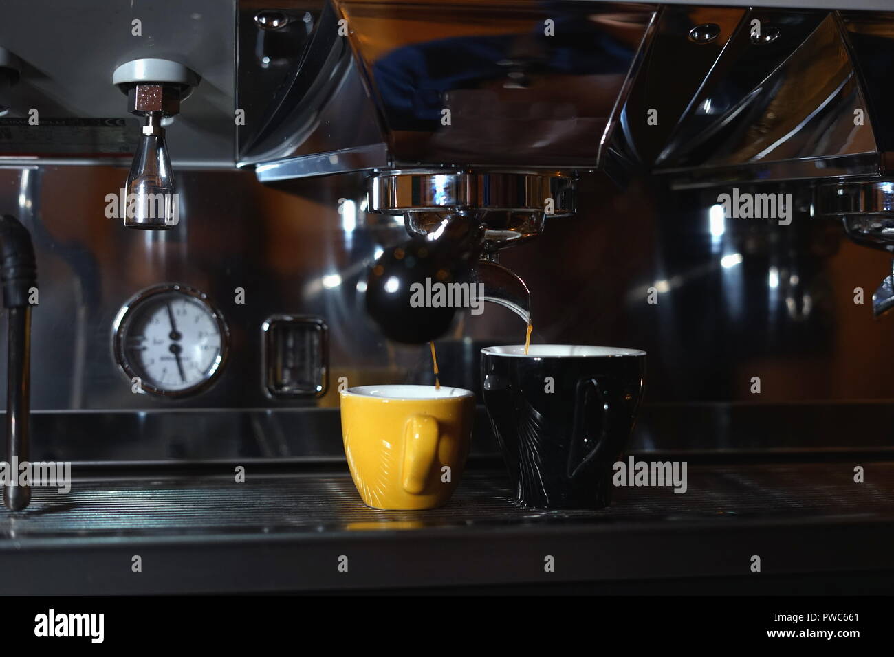 Barista making coffee using a coffee maker Stock Photo Alamy