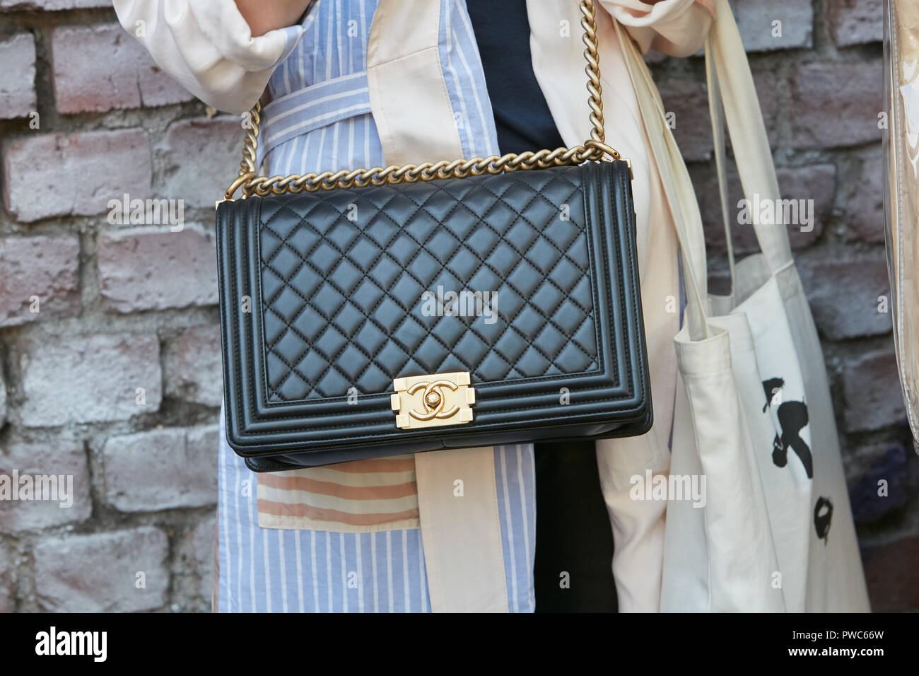 MILAN, ITALY - SEPTEMBER 20, 2018: Woman with black Chanel leather bag ...