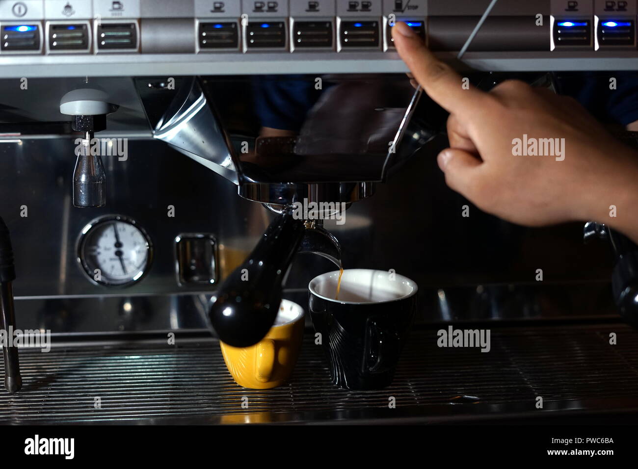 Barista making coffee using a coffee maker Stock Photo Alamy