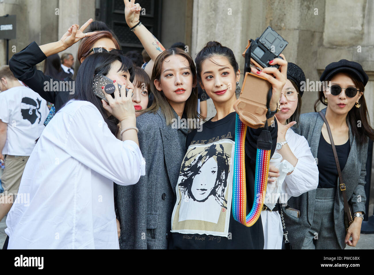 MILAN, ITALY - SEPTEMBER 20, 2018: Women shooting selfies photos before Max Mara fashion show, Milan Fashion Week street style Stock Photo