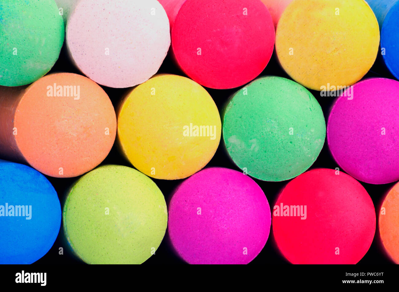 Colored sticks of sidewalk chalk for drawing on pavement, concrete or