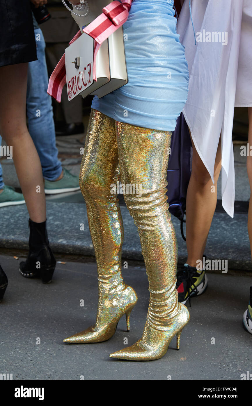 Woman with golden glitter long boots 