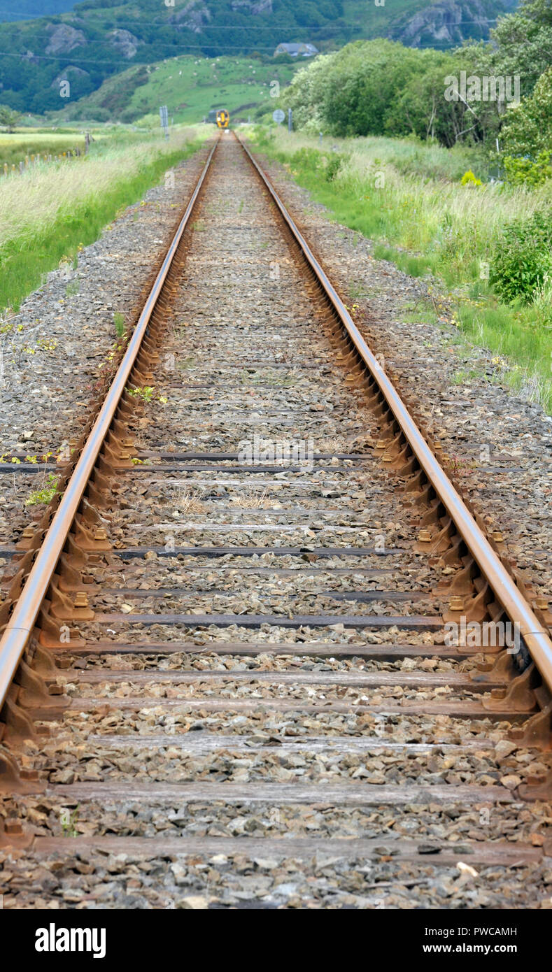 Rural railway line tracks in countryside at Talsarnau, Gwynedd in North Wales UK. Stock Photo