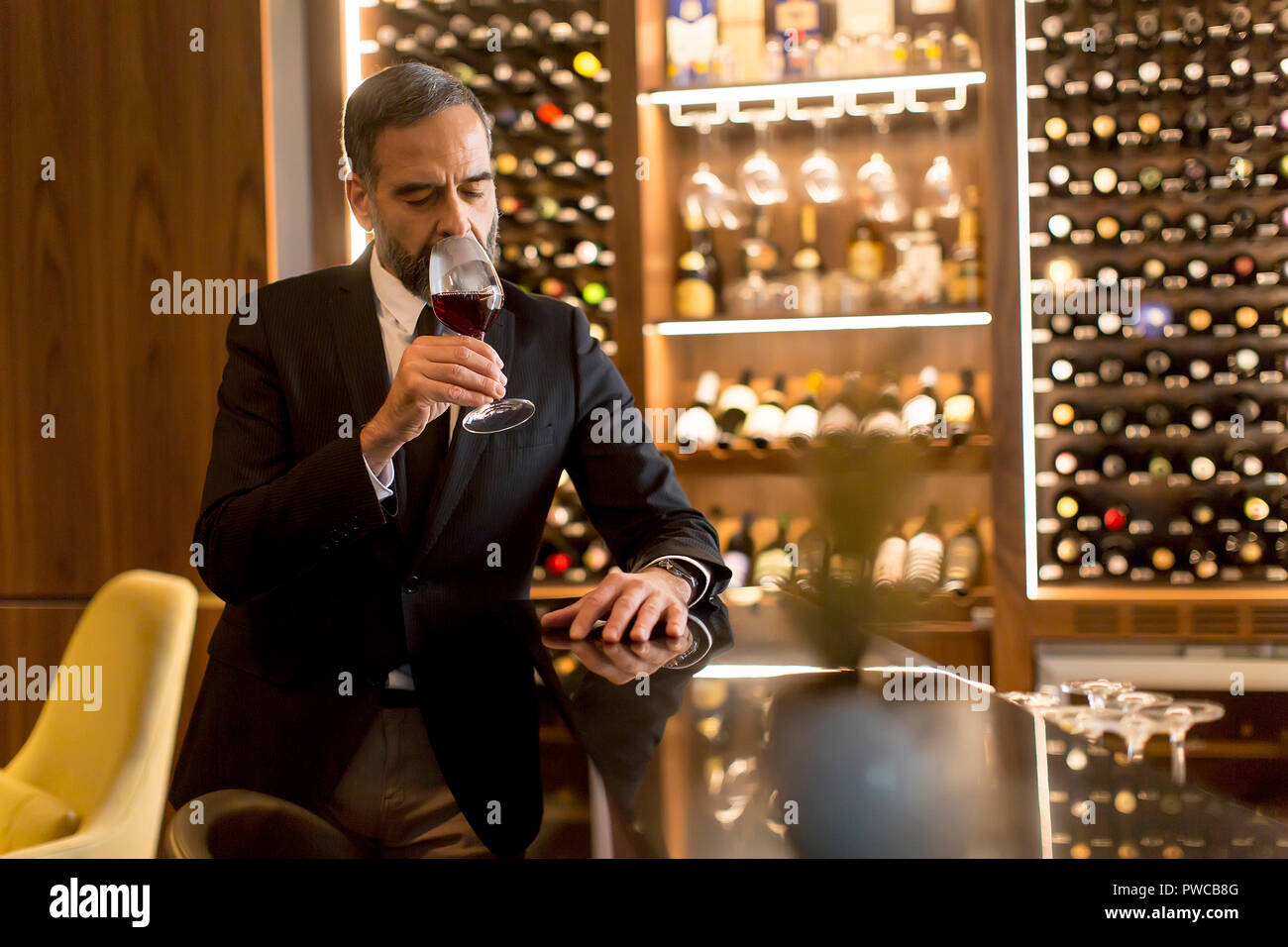Portrait of senior handsome man drinking red wine Stock Photo - Alamy