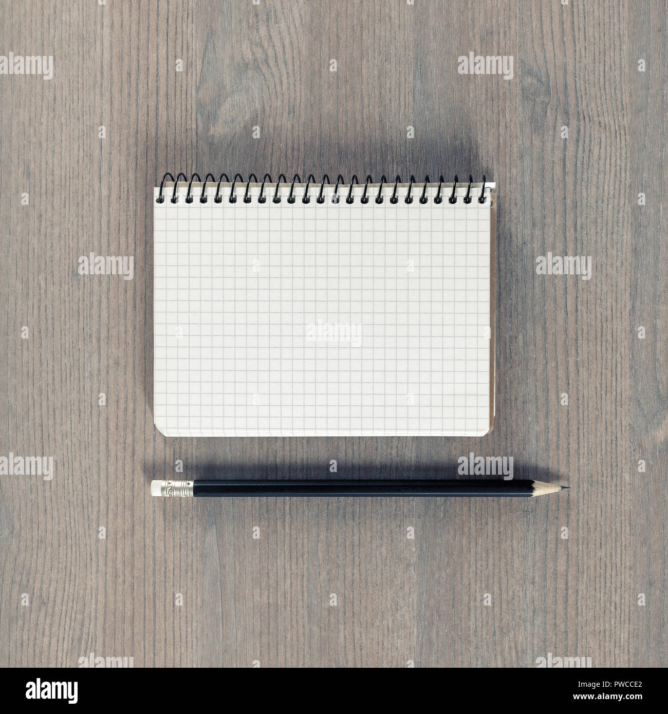 Blank notebook and pencil on wood background. Stationery mockup ...