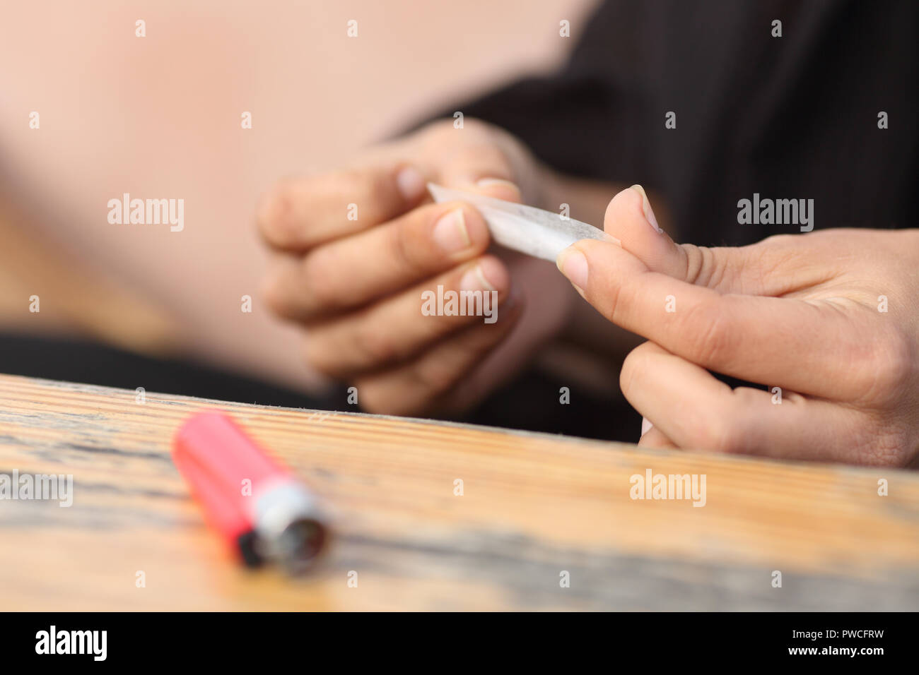 Close up of a woman hands making a cigarette Stock Photo