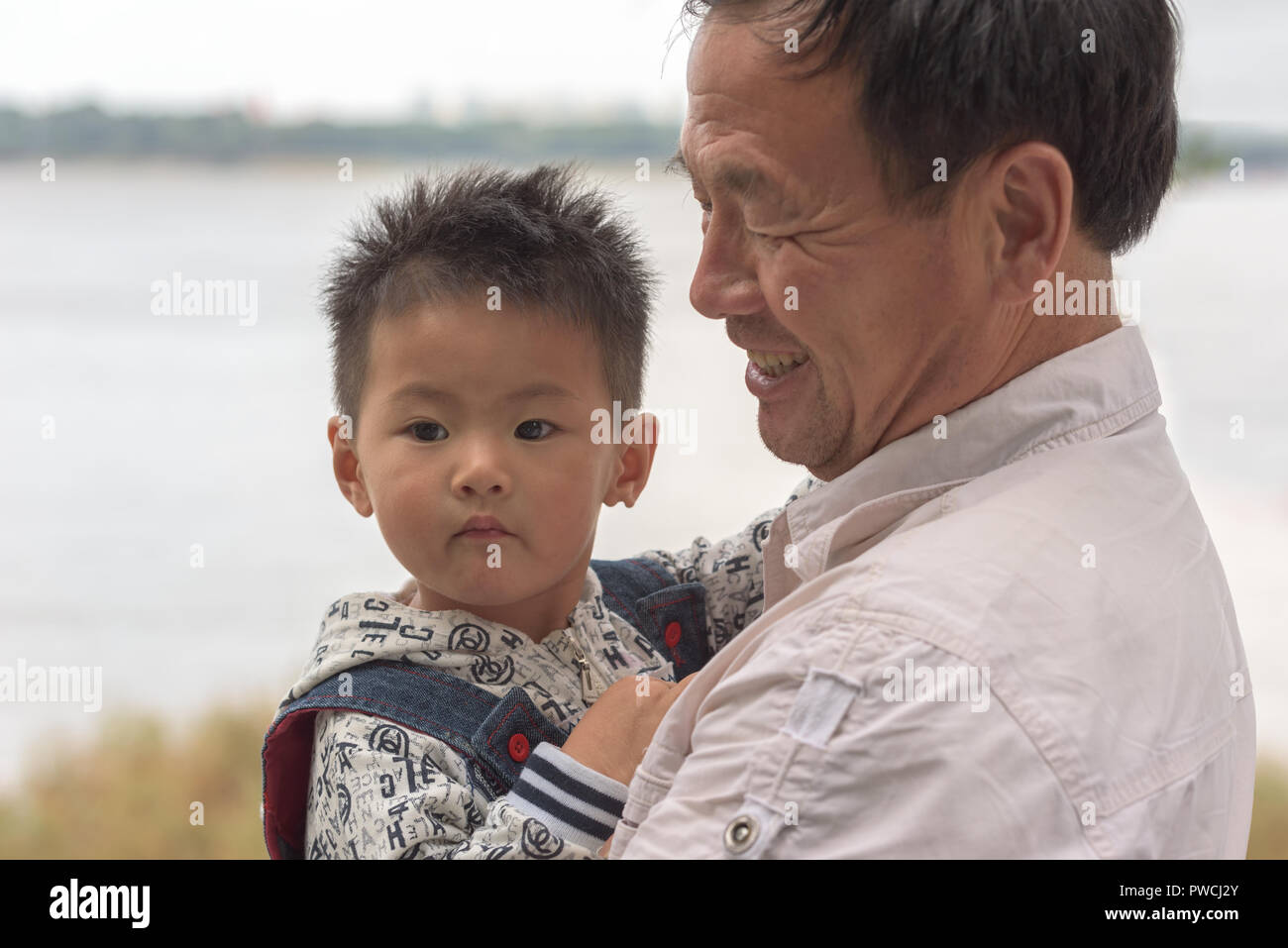 Harbin, Heilongjiang, China - September 2018: Portrait of Asian boy and grandfather. Grandfather with grandson Stock Photo