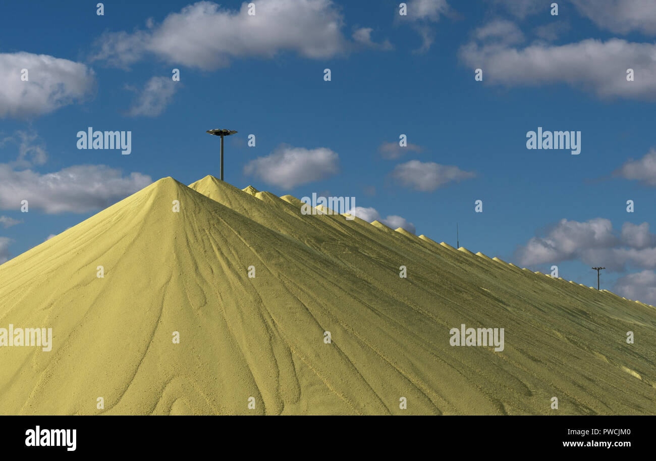 Sulfur piles storage at the PAO Gazprom factory in Astrakhan, Russia. Stock Photo