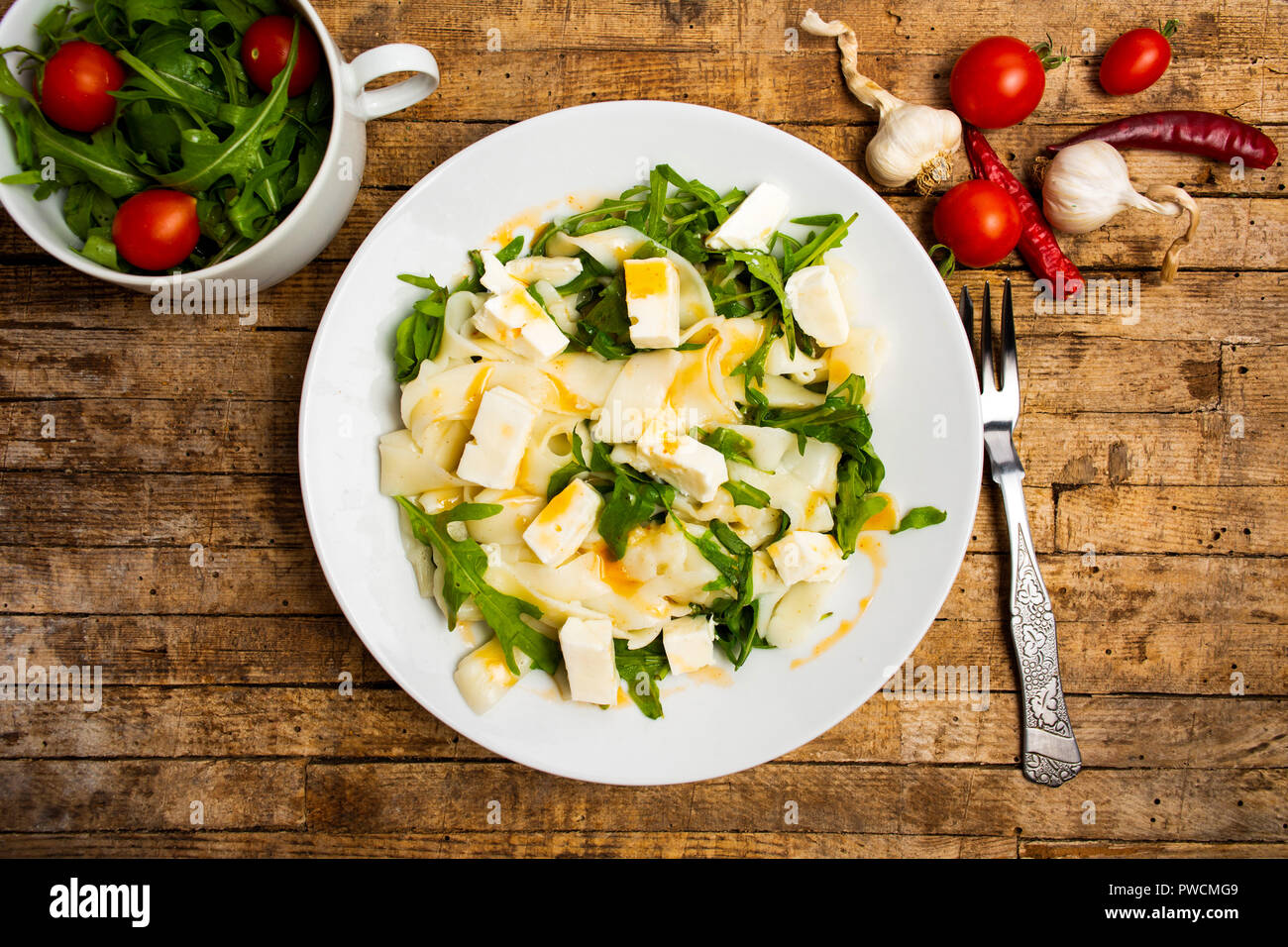 Homemade pasta with arugula served on a plate Stock Photo