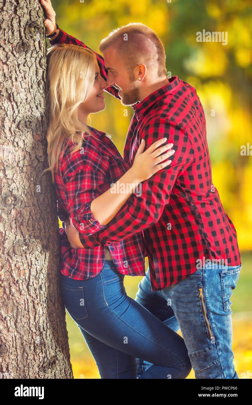 Young couple in love hugging and kissing in autumn park Stock Photo - Alamy