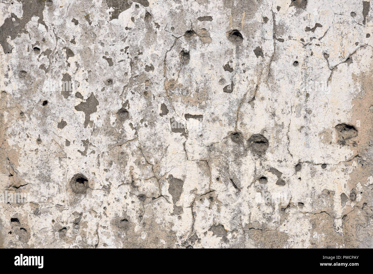 Concrete wall background with bullet holes, potholes from weapon shooting Stock Photo