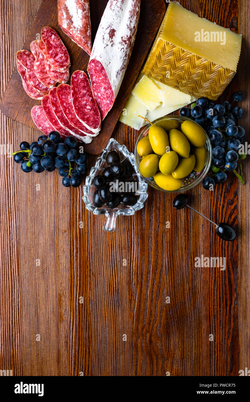 Mix of different snacks and appetizers. Spanish tapas on a wooden plate ...