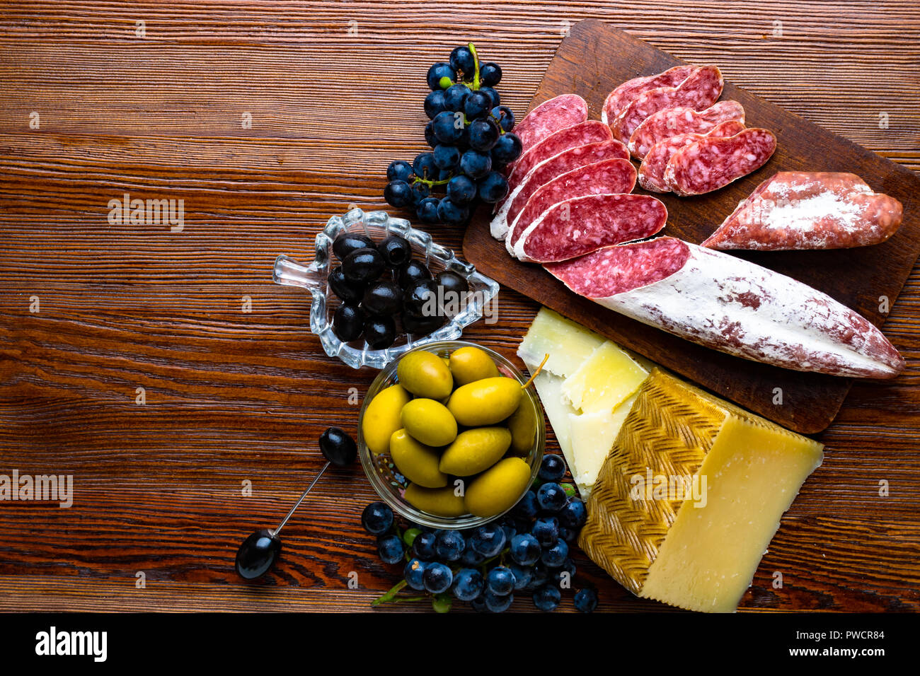 Mix of different snacks and appetizers. Spanish tapas on a wooden plate ...