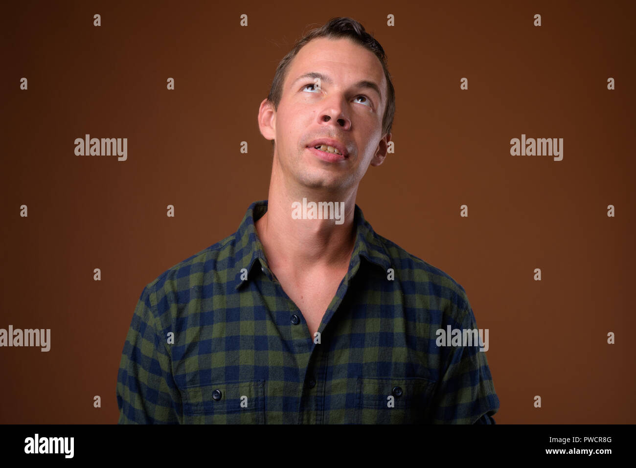 Studio shot of man against brown background Stock Photo