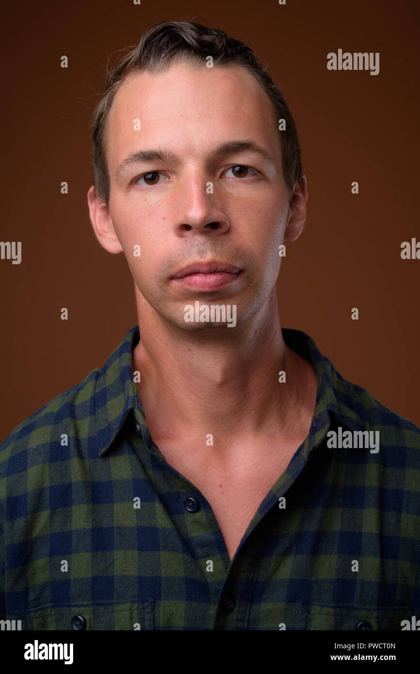 Studio shot of man against brown background Stock Photo