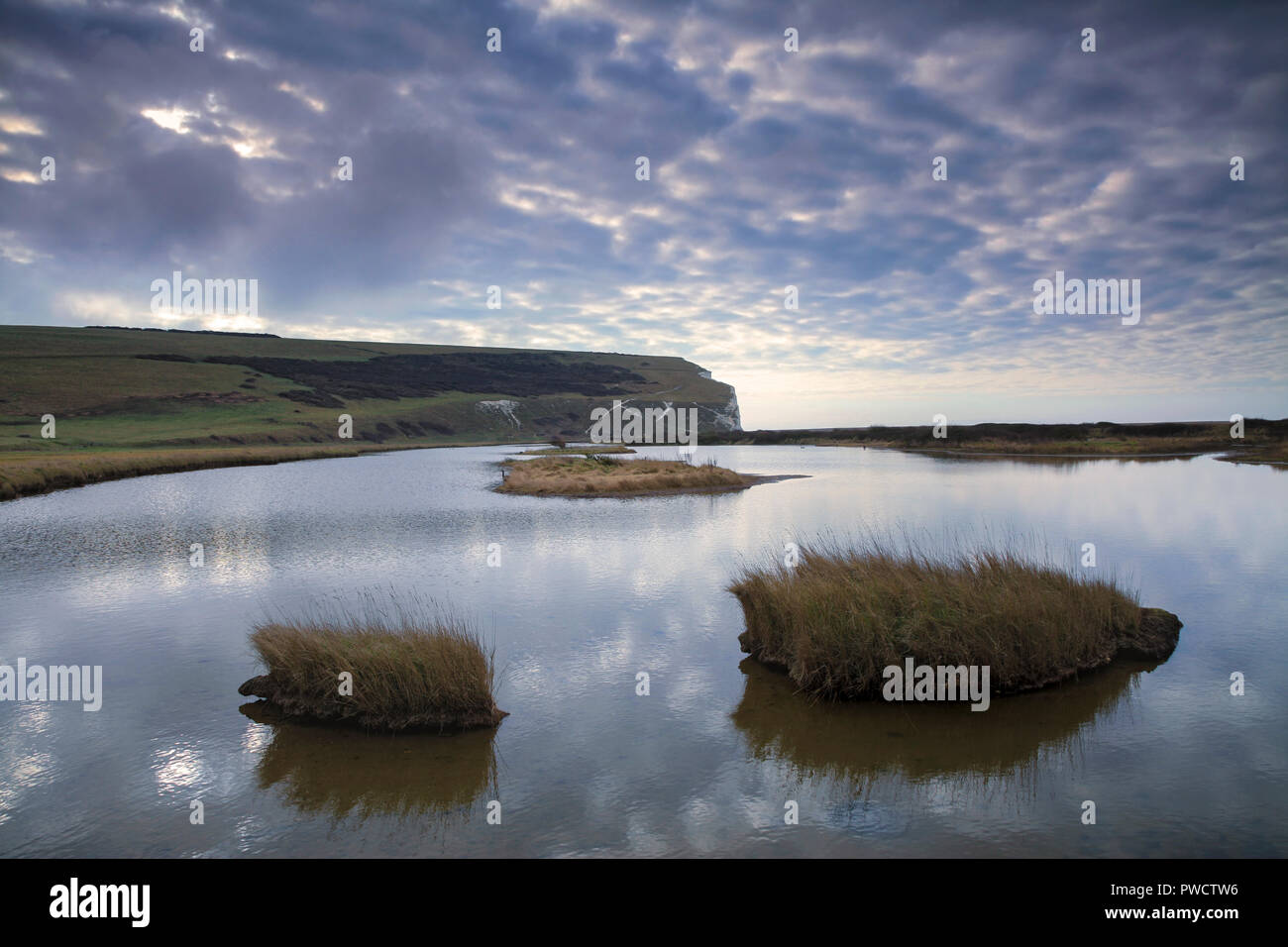 Tranquil Cuckmere Haven at dusk looking towards start Seven Sisters. Stock Photo