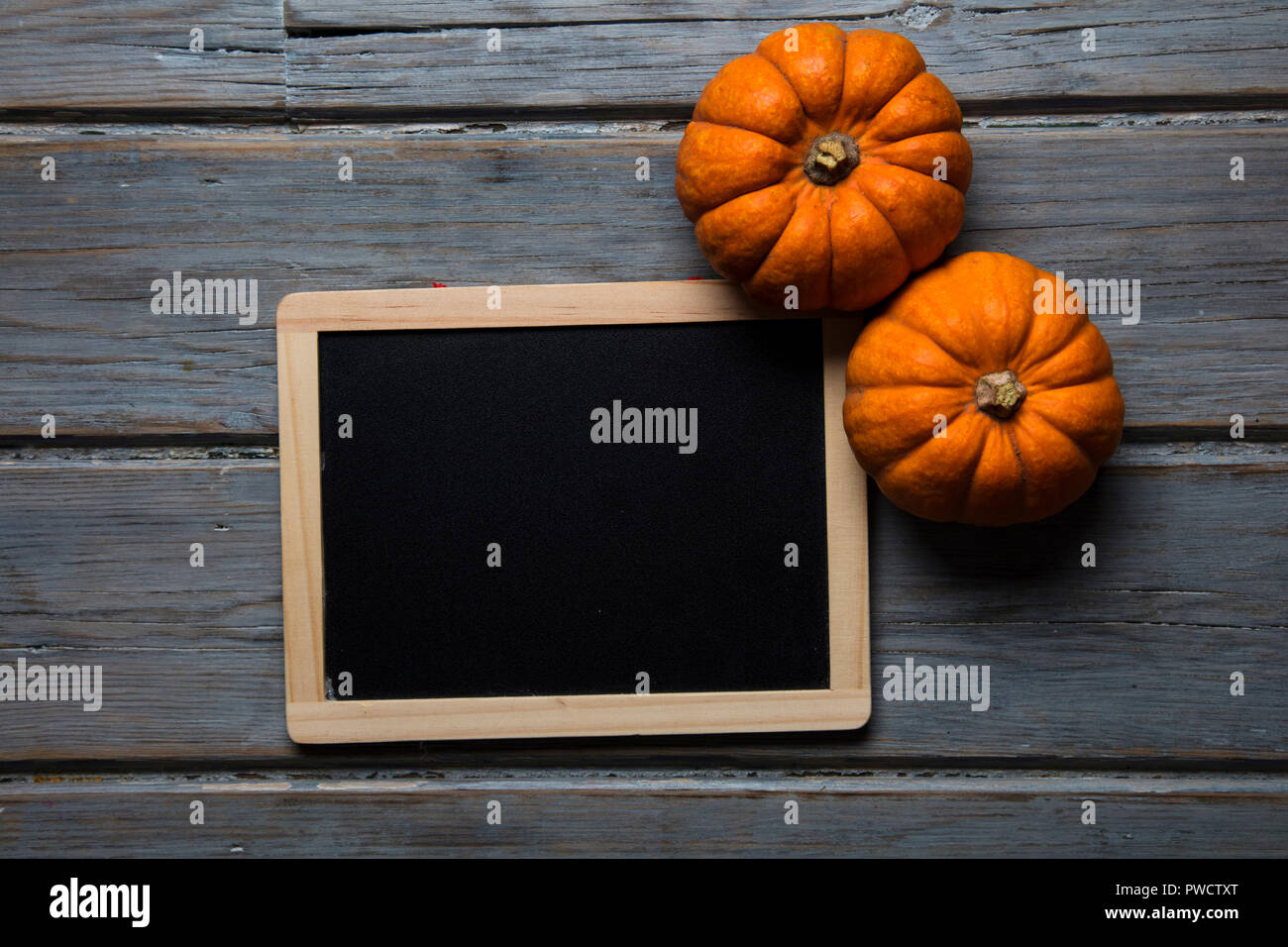 MIni pumpkins arranged on a rustic wooden background Stock Photo - Alamy