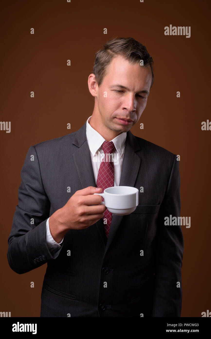 Studio shot of businessman against brown background Stock Photo