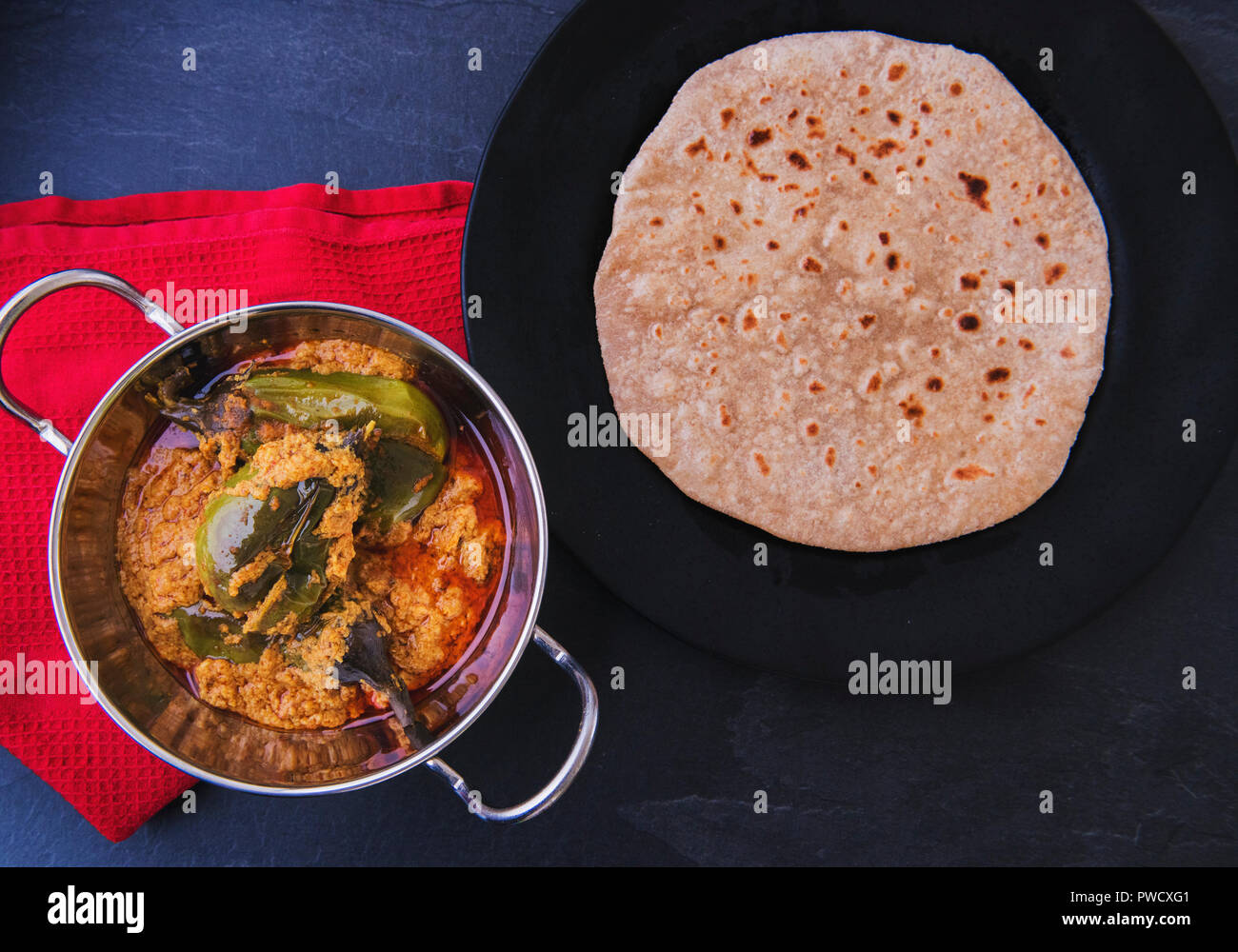 Indian Eggplant masala curry with Roti Stock Photo Alamy