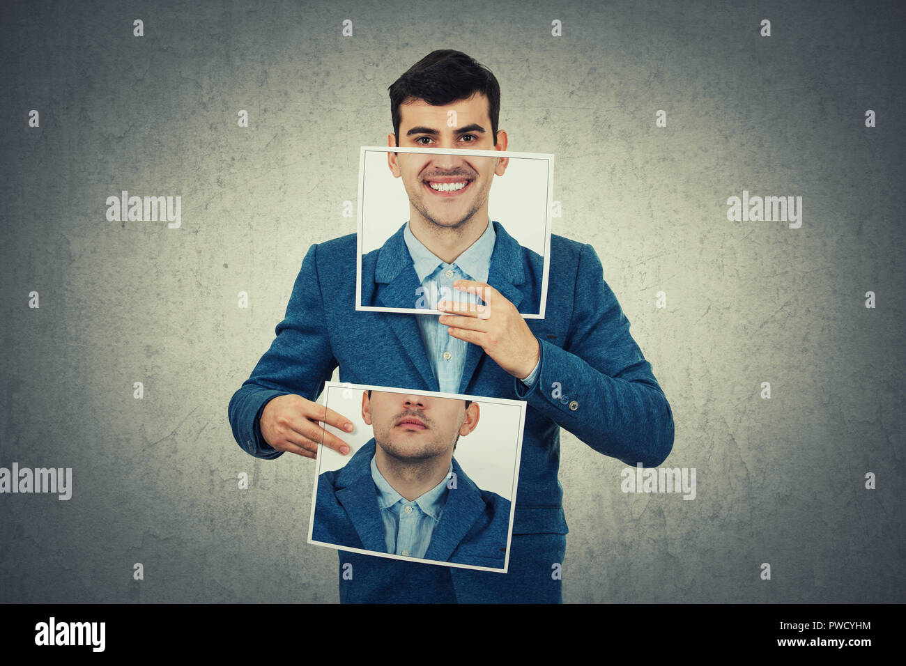 Businessman holding two white photo sheets with different portrait emotions, one hiding half face with angry expression on and another with a happy, s Stock Photo
