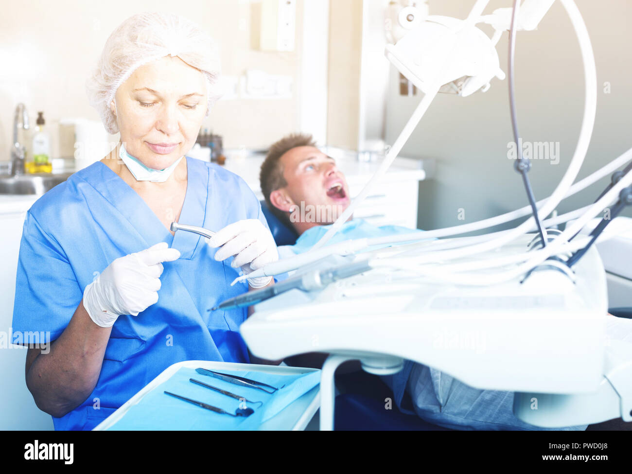 Female dentist with male patient in modern dentistry Stock Photo - Alamy