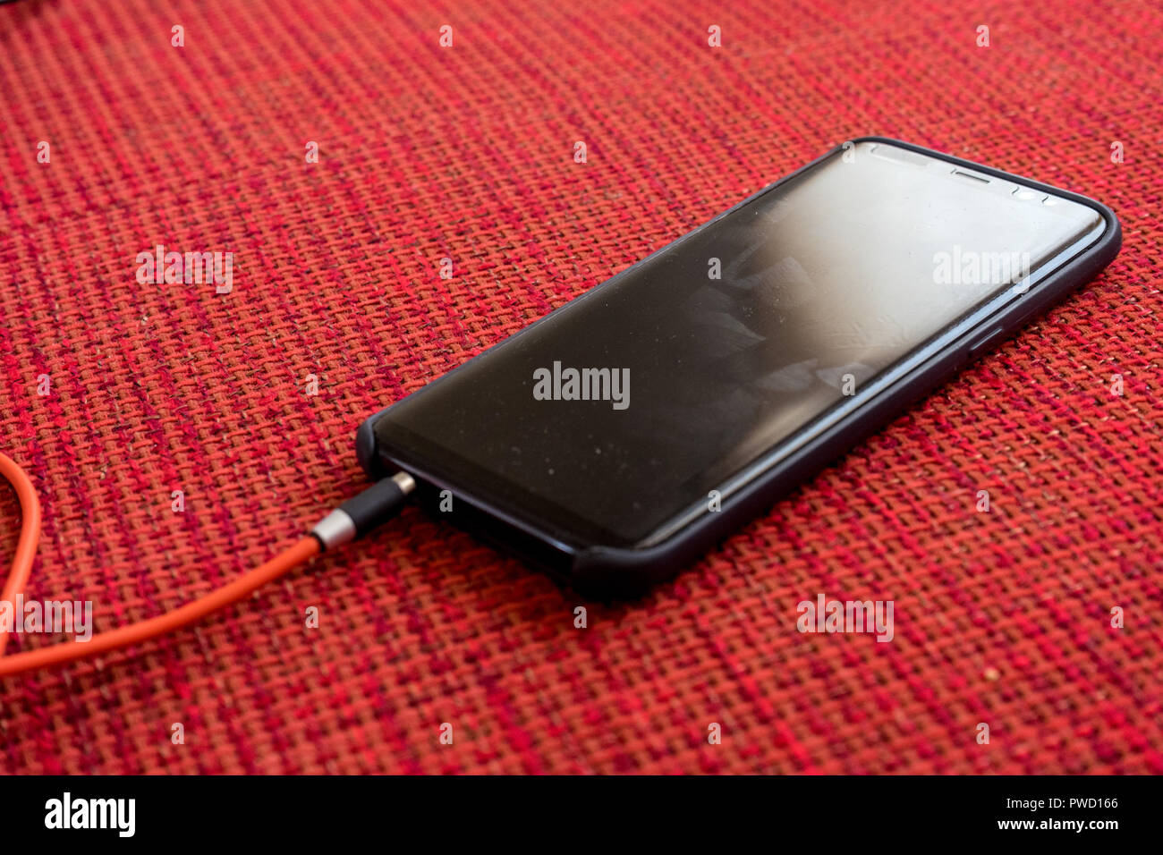 Netherlands, Hague, Schiphol, Europe, a black cellphone with a headphone jack Stock Photo
