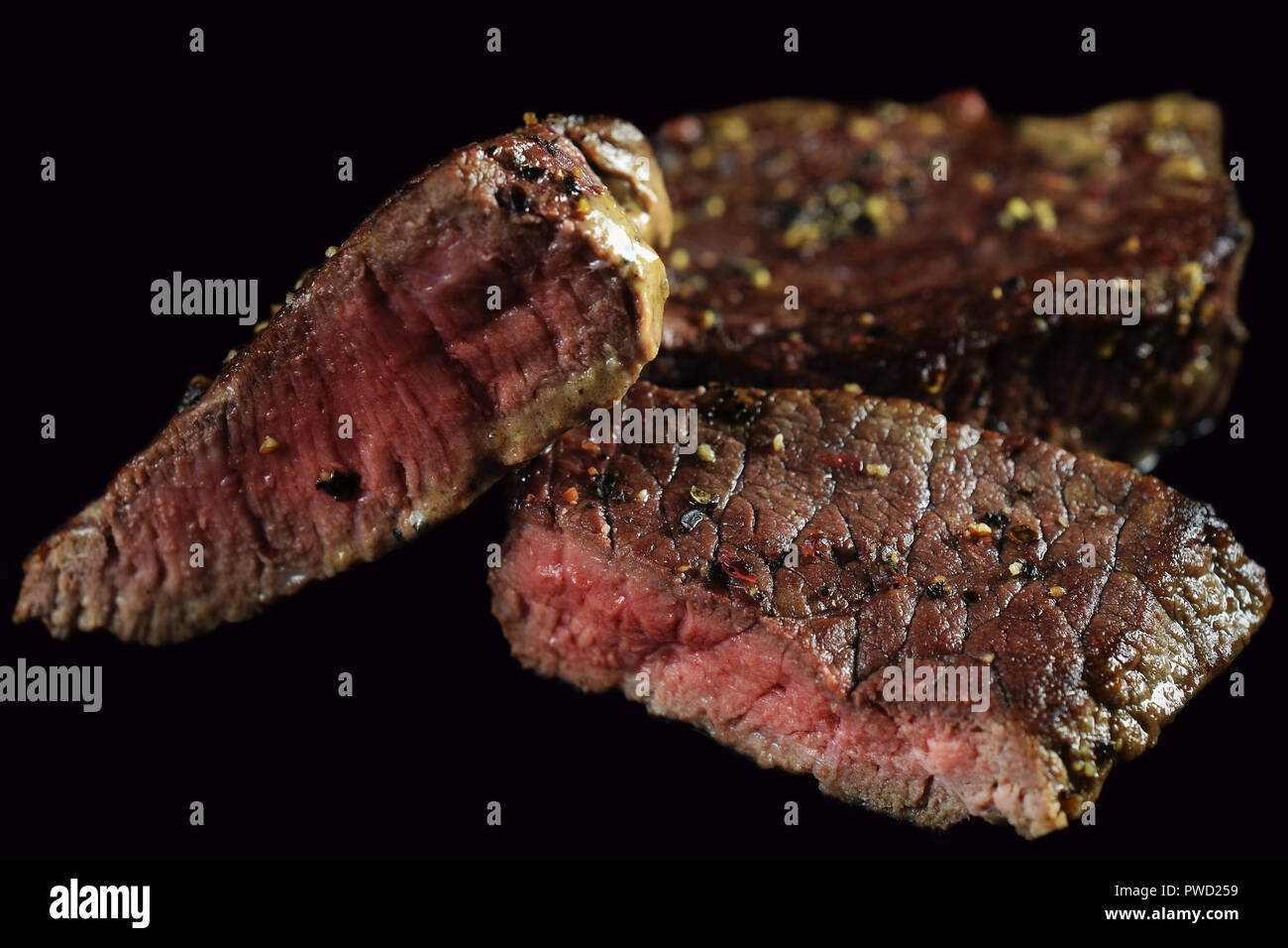 Medium rare steak close up. Isolated on black. Stock Photo