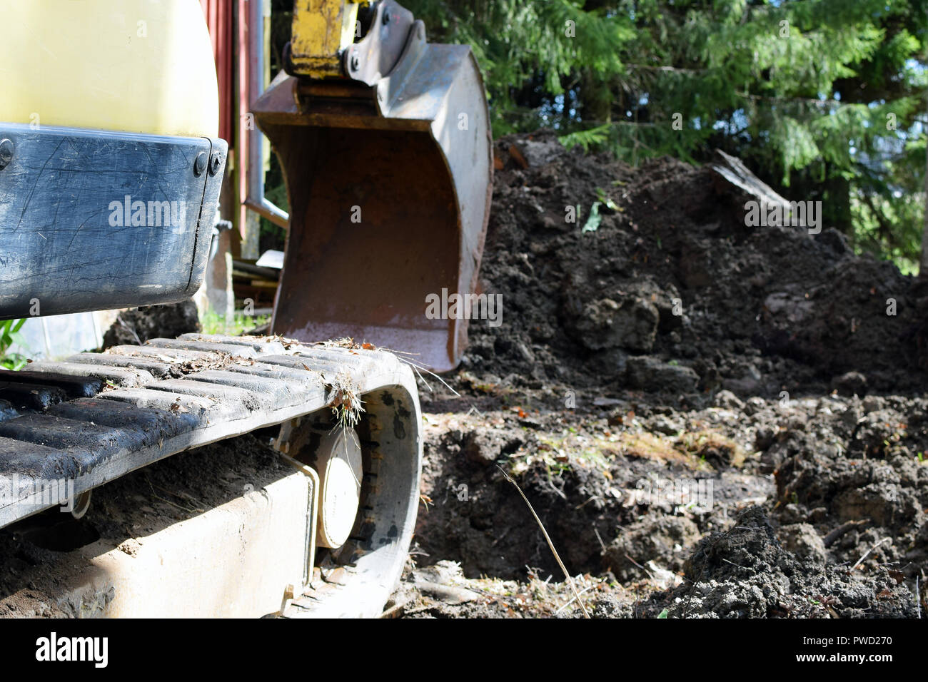 Close up side view of excavator and bucket on contruction site. Selective focus. Stock Photo