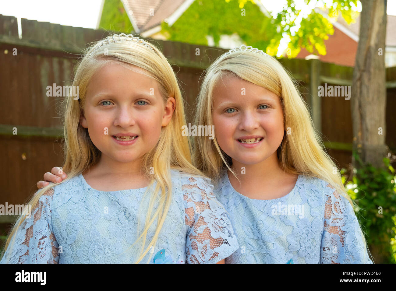 Portrait of pre teen twin caucasian girls looking at the camera Stock Photo