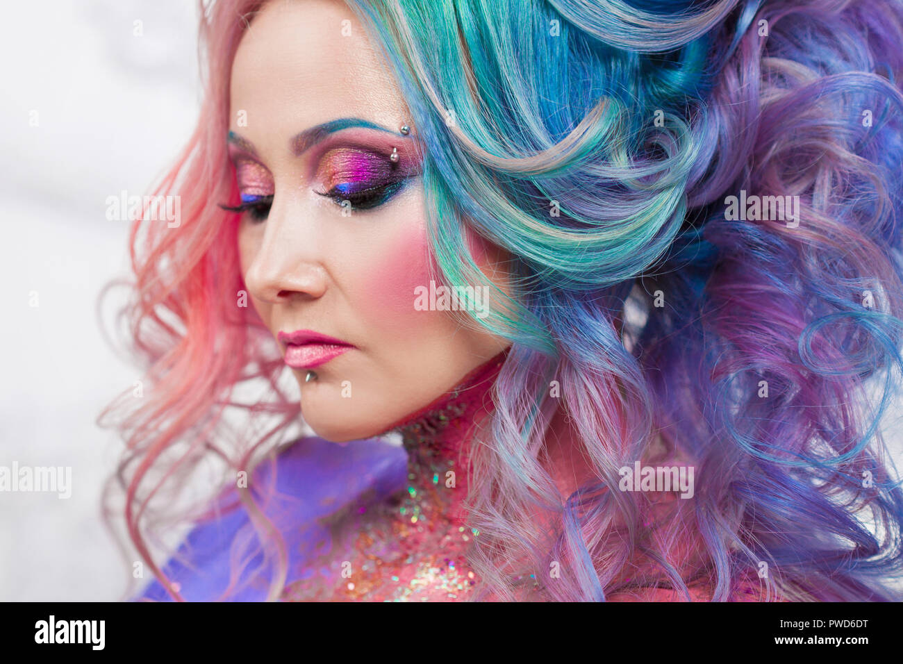 Beautiful woman with bright hair. Bright hair color, hairstyle with the curls. Stock Photo