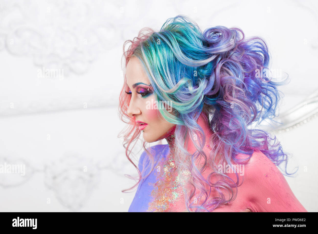 Beautiful woman with bright hair. Bright hair color, hairstyle with the curls. Stock Photo