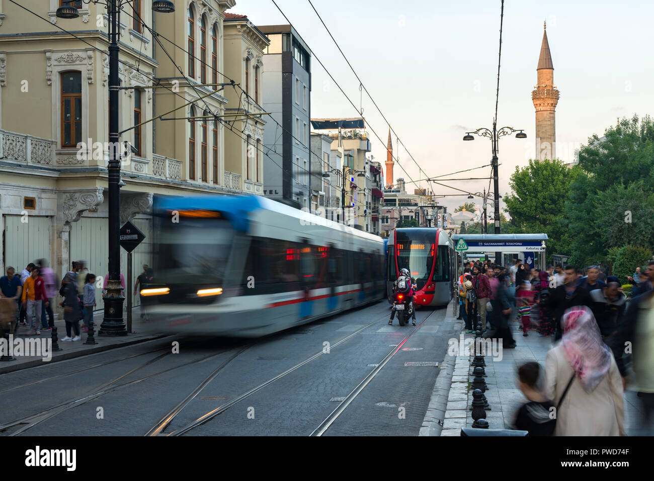 Sultanahmet T1 tram station with trams arriving and departing as people queue, Istanbul, Turkey Stock Photo