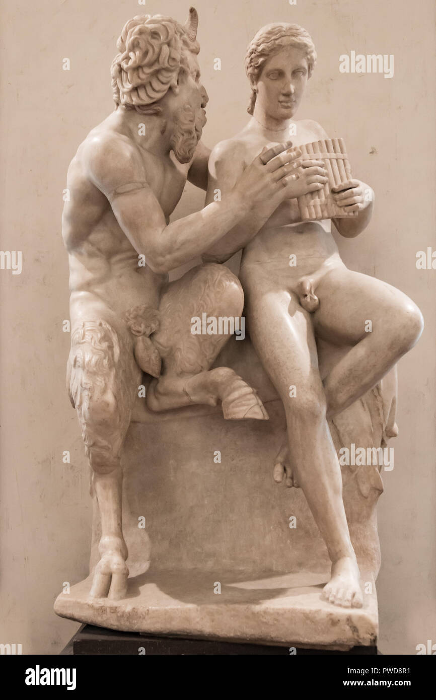 A 2nd century restored marble sculpture of Pan teaching Daphnis to play the flute  attributed to Heliodorus of Rhodes on display in the Uffizi Gallery in Florence, Italy. Stock Photo