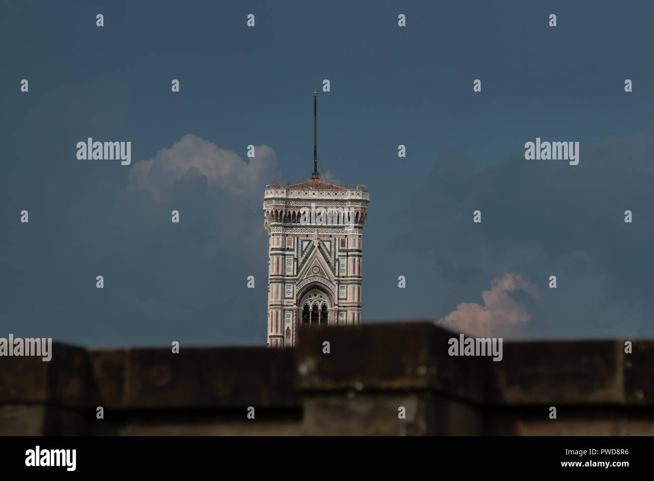 Parts of the Duomo peek over the wall at an outdoor cafe at the Uffizi Gallery in Florence, Italy. Stock Photo