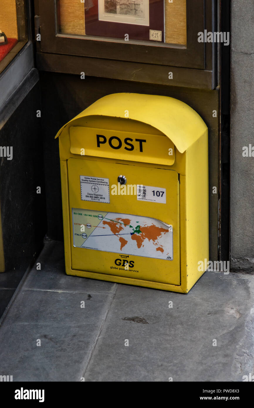 A yellow mail box sits on the sidewalk in a shop doorway in Florence, Italy  Stock Photo - Alamy