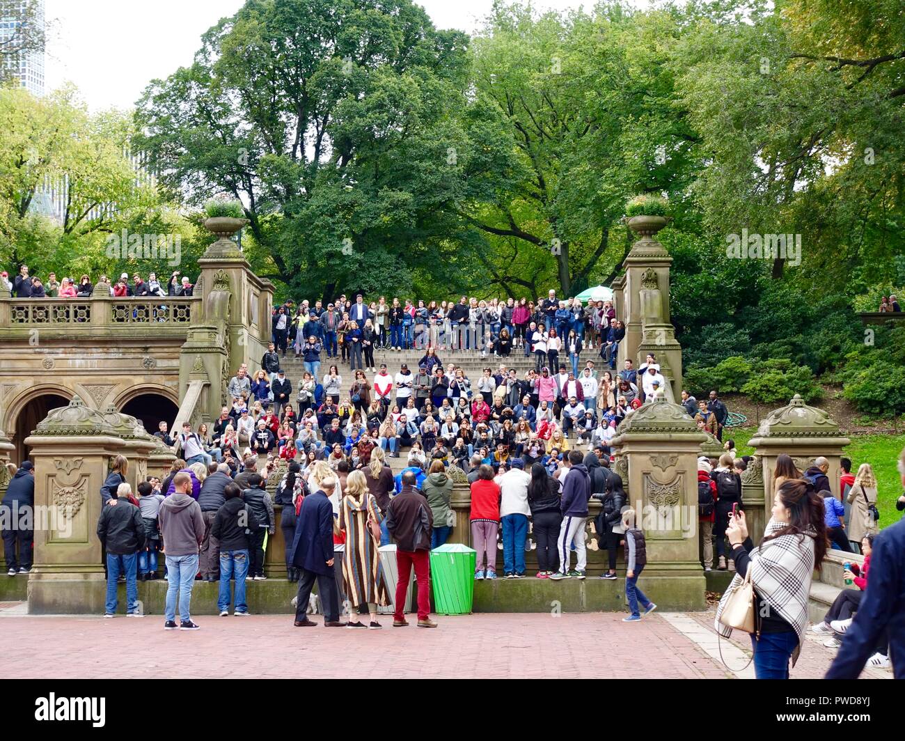 Crowd of people watching performers from steps near Belvedere Fountain in Central Park, New York, USA Stock Photo