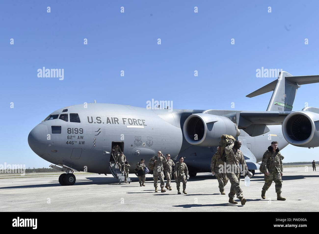 A contingency response element arrives at Tyndall Air Force Base onboard a Joint Base Lewis-McChord C-17 Globemaster III, Oct. 12, 2018, October 12, 2018. The mobility Airmen of this contingency response team deployed to assess damage and establish conditions for the re-initiation of airflow, bringing much needed equipment, supplies and personnel for the rebuilding of the base in the aftermath of Hurricane Michael. AMC equipment and personnel stand by across the nation to provide even more support upon request. (U.S. Air Force photo by Tech. Sgt. Liliana Moreno). () Stock Photo