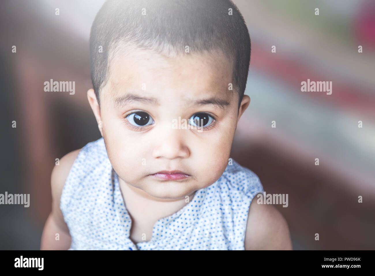 Cute little Asian 1 year old toddler baby girl child unhappy and looking up in the park, Angry little kid with sad expressions Stock Photo