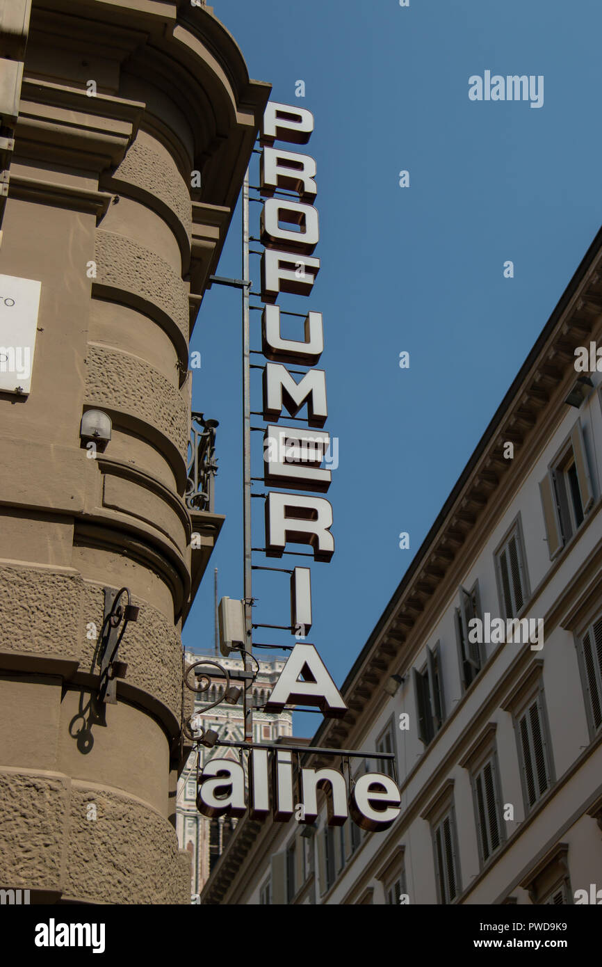 The Profumeria Aline sign juts out from the building in Florence, Italy. Stock Photo