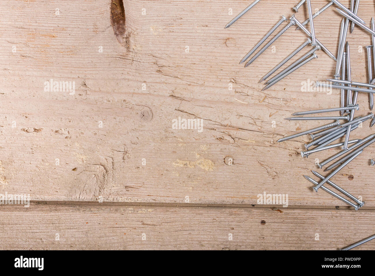 wooden hardware nails on rough surface Stock Photo