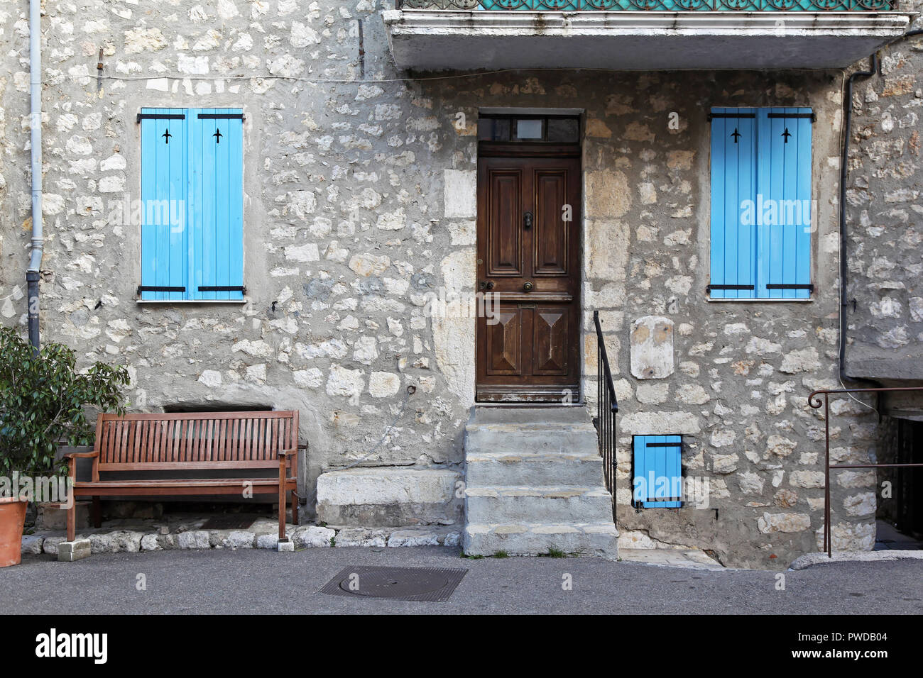 Old stone house with blue windows and bench Stock Photo - Alamy