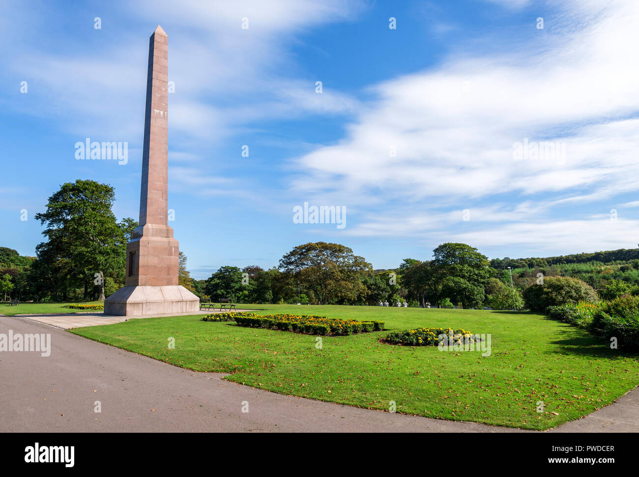 Magnificent McGrigor Obelisk with flower beds in front on a blue sky background, Duthie Park, Aberdeen, Scotland Stock Photo