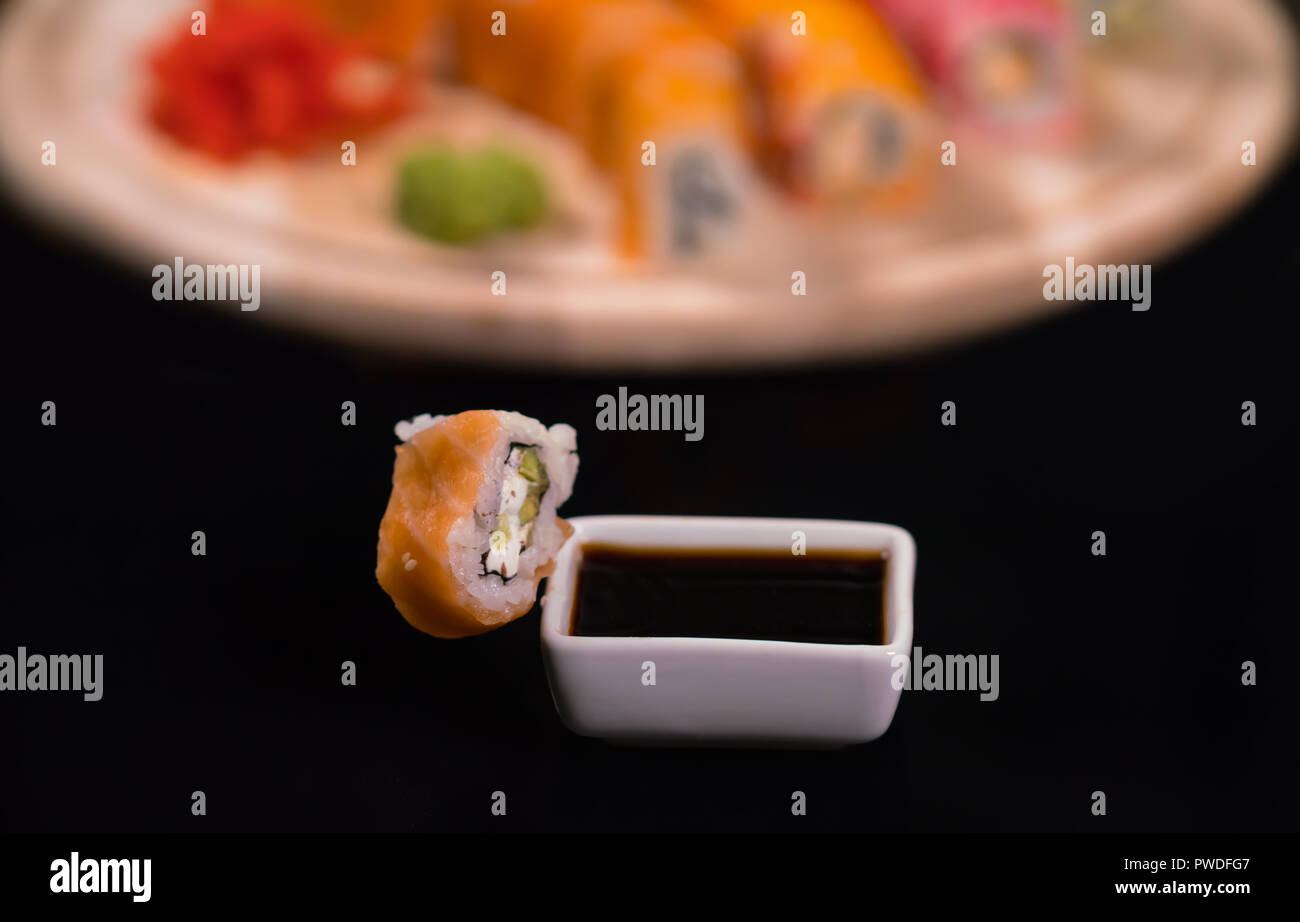 Piece of fresh California maki sushi with soya sauce Stock Photo